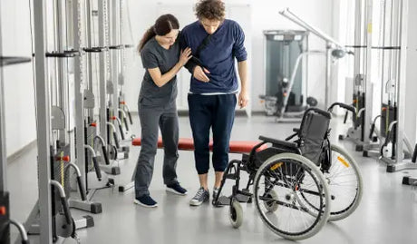 Modern rehabilitation clinic setup featuring electric hi-lo treatment tables, parallel bars, and clinical-grade electrotherapy units.