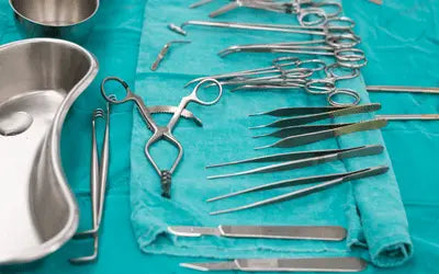 Selection of high-grade stainless steel surgical instruments, including hemostats, scalpel handles, and specialized surgical retractors.